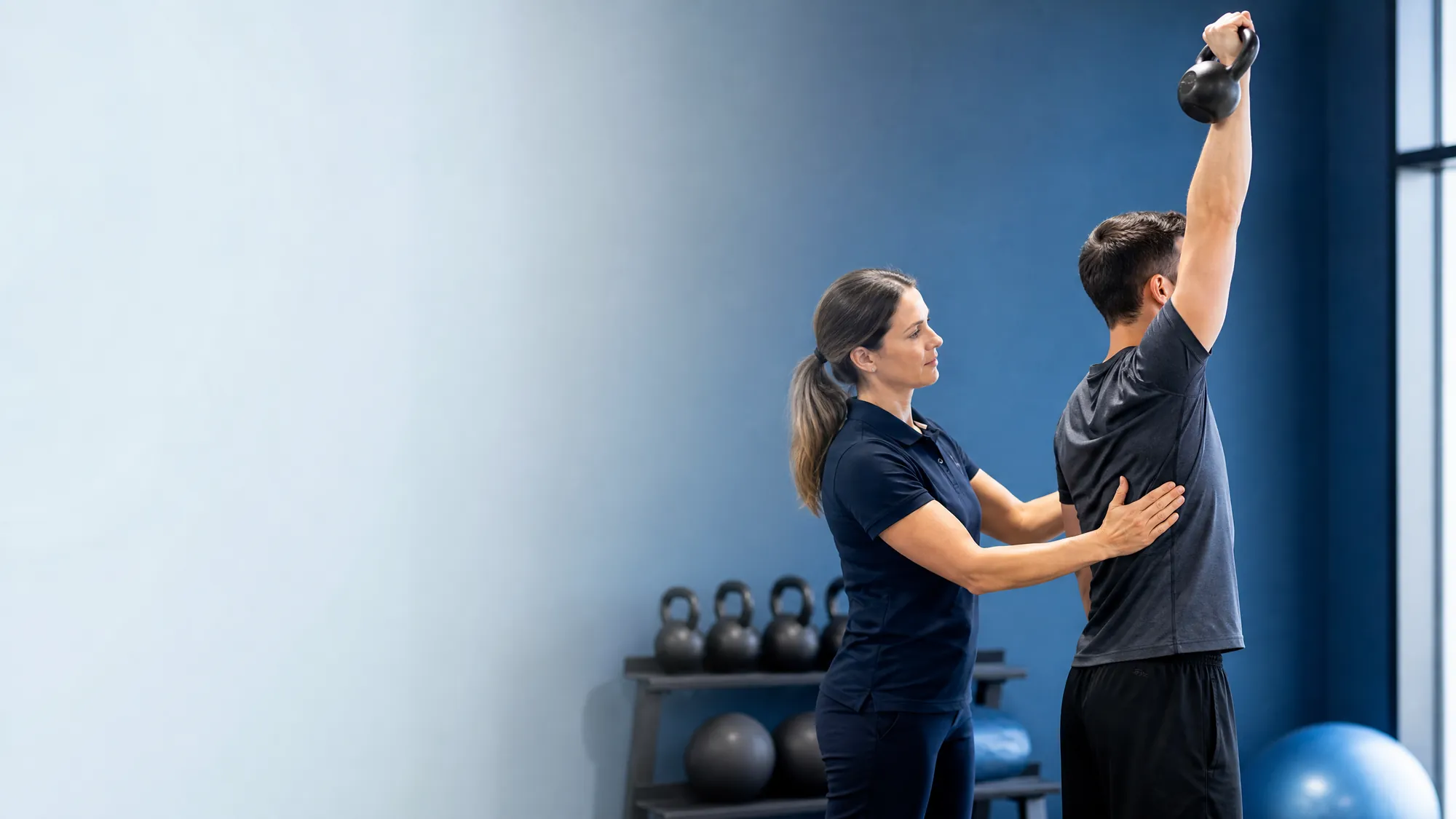 Performance practitioner assessing an athlete’s overhead movement and range of motion.
