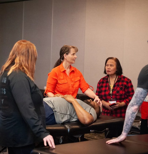 image-500x520-filled Clinician performing a precise cranial and upper cervical spine assessment on a seated patient in a treatment room, illustrating hands-on evaluation for persistent post-concussion symptoms.